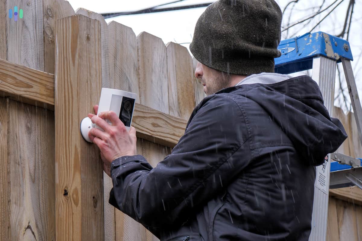 Ring Spotlight Cam Pro being mounted on a fence